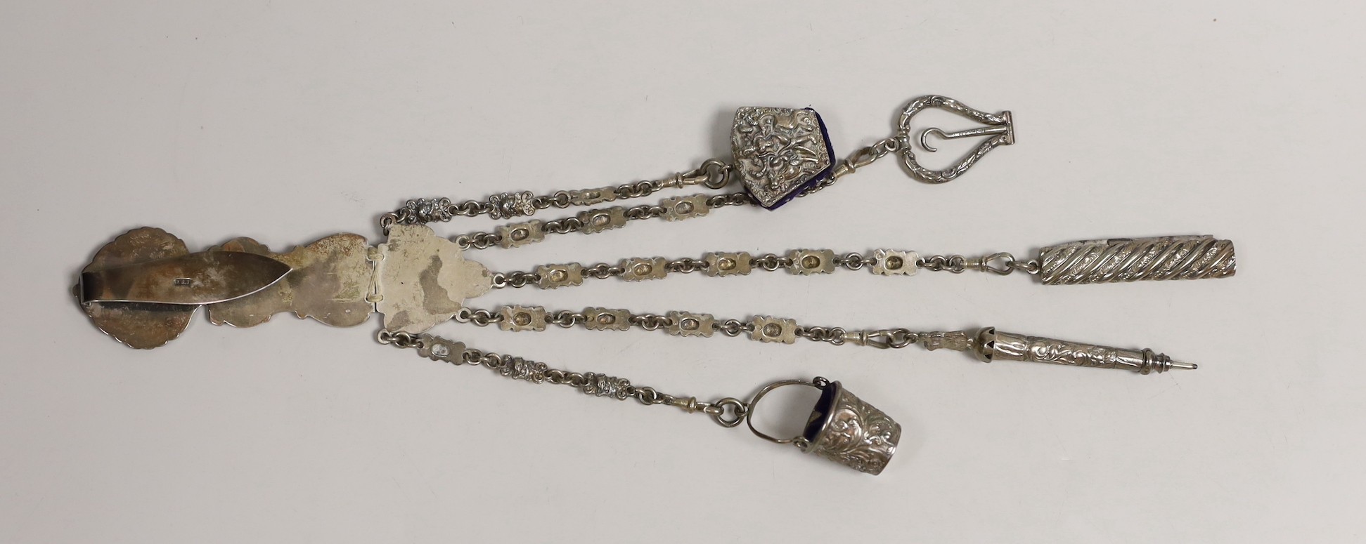 A Victorian white metal chatelaine with five accessories, import maker's mark for B.H. Joseph & Co, 32.7cm.